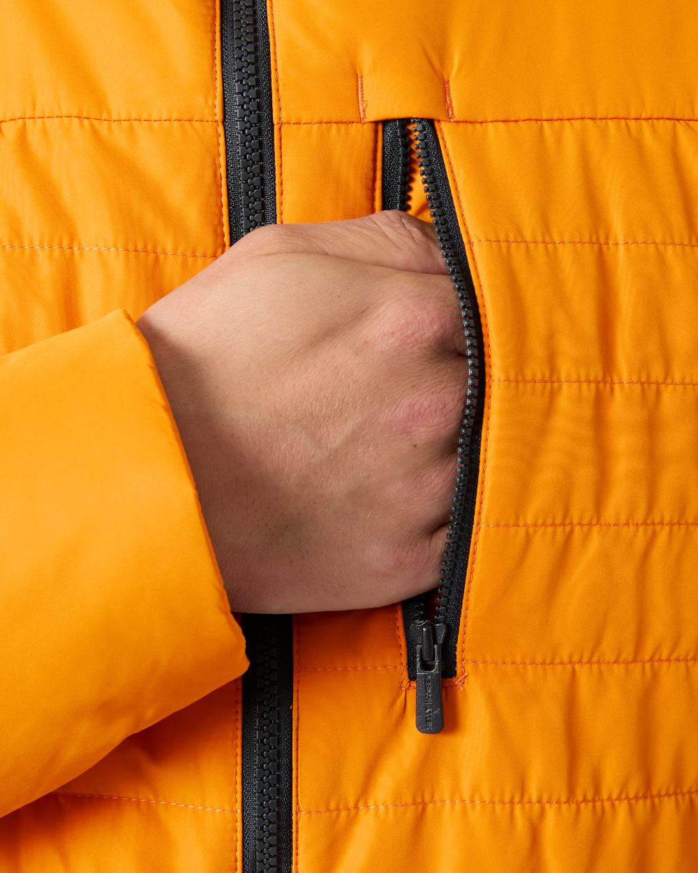 Ignite Orange coloured Helly Hansen Mens Crew Insulated Sailing Jacket 2.0 on white background 