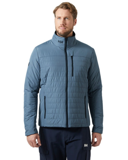 Washed Navy coloured Helly Hansen Mens Crew Insulated Sailing Jacket 2.0 on white background 