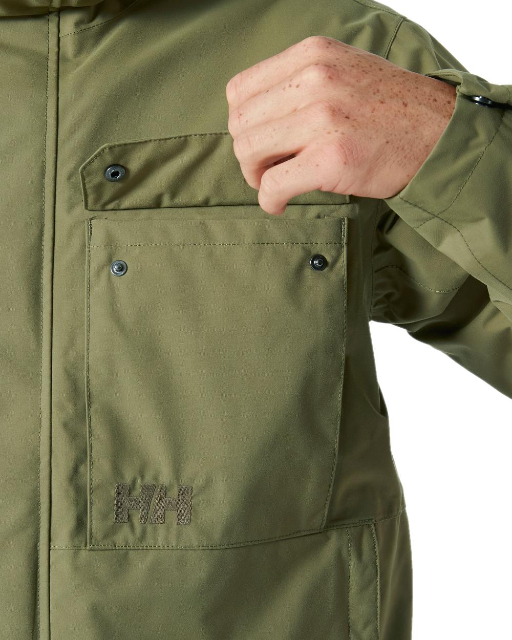 Terrain Green coloured Helly Hansen Mens Escape Rain Jacket on white background 