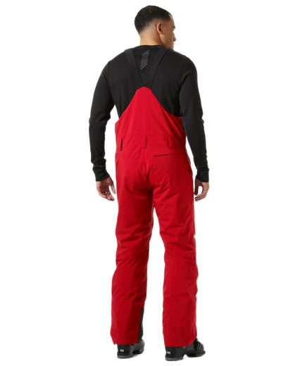 Red Coloured Helly Hansen Mens Legendary Insulated Bib Pants on white background 
