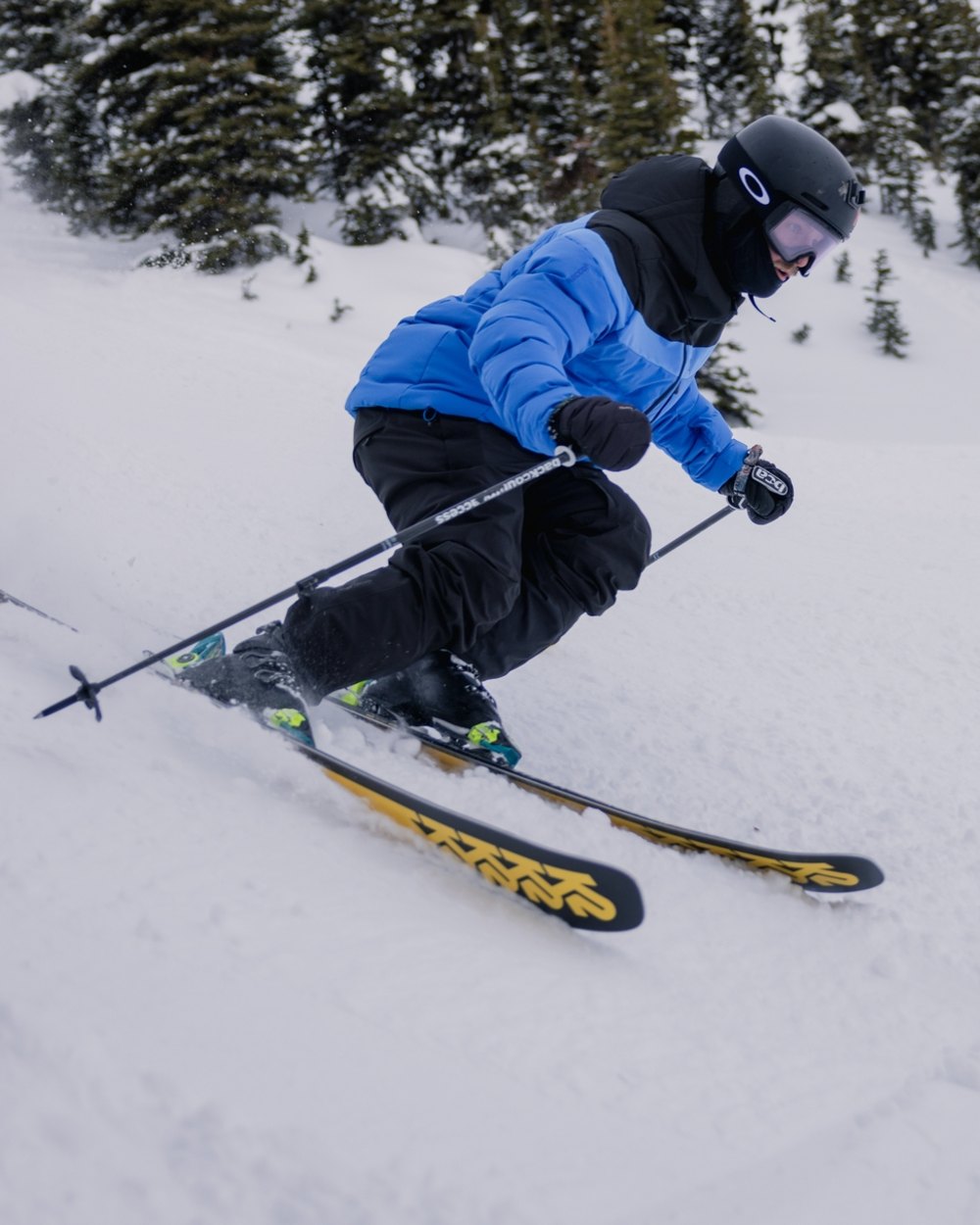Black Coloured Helly Hansen Mens Legendary Insulated Ski Pants on snow background 