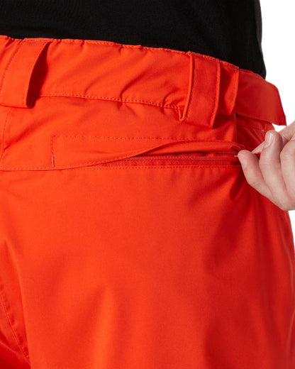Cherry Tomato Coloured Helly Hansen Mens Legendary Insulated Ski Pants on white background 