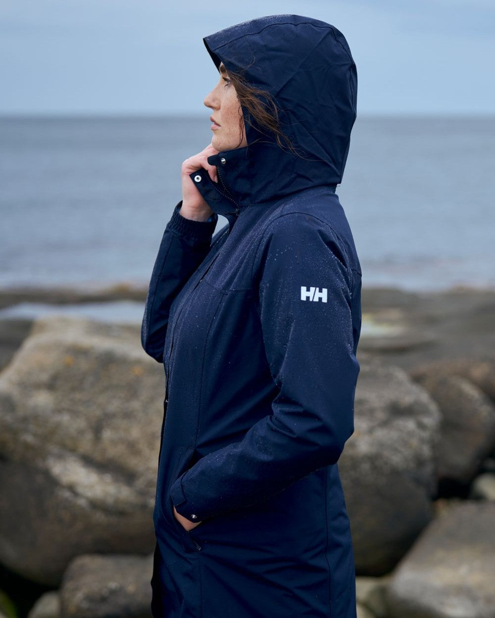 Navy coloured Helly Hansen Womens Aden Long Rain Coat on white background 