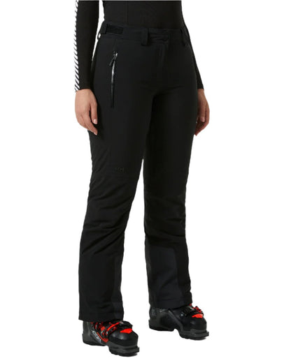 Black Coloured Helly Hansen Womens Alphelia 2.0 Insulated Ski Pants on white background 