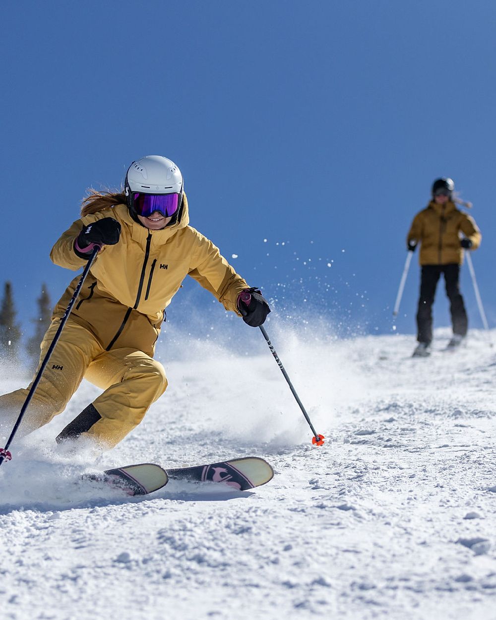 Sand Coloured Helly Hansen Womens Alphelia Ski Jacket on snow background 