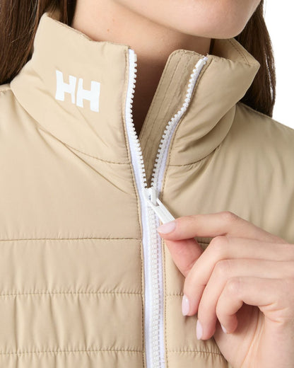 Khaki Sand coloured Helly Hansen Womens Crew Insulated Sailing Jacket 2.0 on white background 