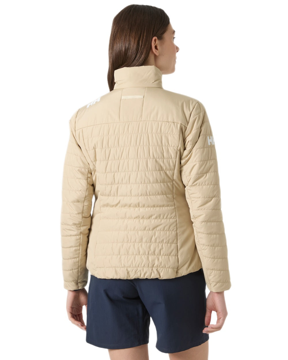 Khaki coloured Helly Hansen Womens Crew Insulated Sailing Jacket 2.0 on white background 
