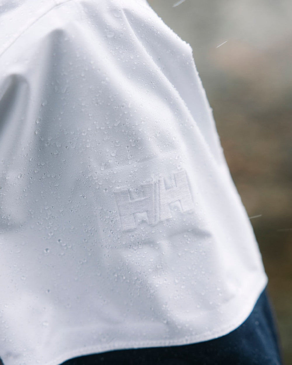 White coloured Helly Hansen Womens Koster Raincoat on blurry background 