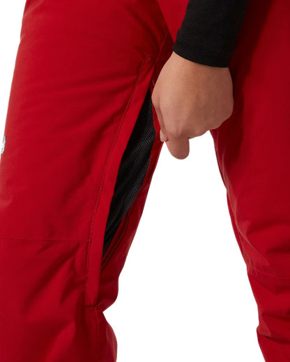 Red Coloured Helly Hansen Womens Legendary Insulated Bib Pants on white background 
