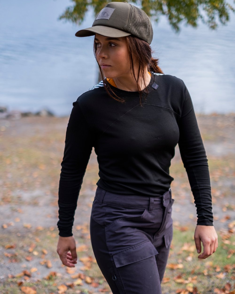 Black Coloured Helly Hansen Womens Lifa Long Sleeve Crew Base Layer on blurry background 