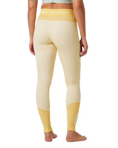 Yellow Cream Coloured Helly Hansen Womens Lifa Merino Midweight 2-In-1 Base Layer Pants on white background 