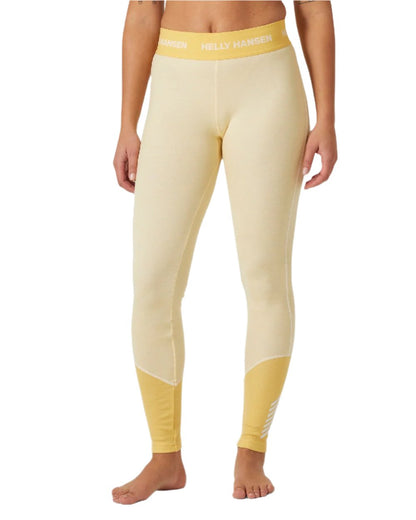 Yellow Cream Coloured Helly Hansen Womens Lifa Merino Midweight 2-In-1 Base Layer Pants on white background 