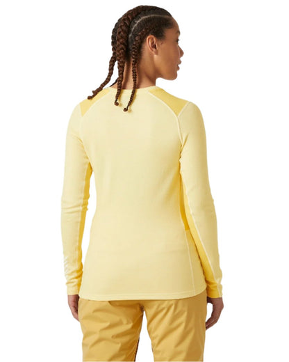 Yellow Cream Coloured Helly Hansen Womens Lifa Merino Midweight Crew Base Layer on white background 