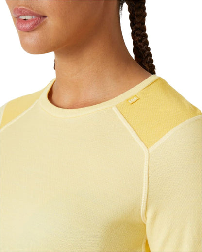 Yellow Cream Coloured Helly Hansen Womens Lifa Merino Midweight Crew Base Layer on white background 