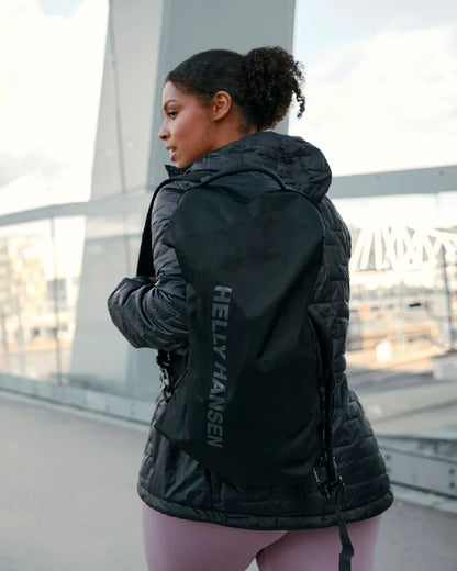 Black Matte Coloured Helly Hansen Womens Lifaloft Hooded Insulated Jacket on bridge background 