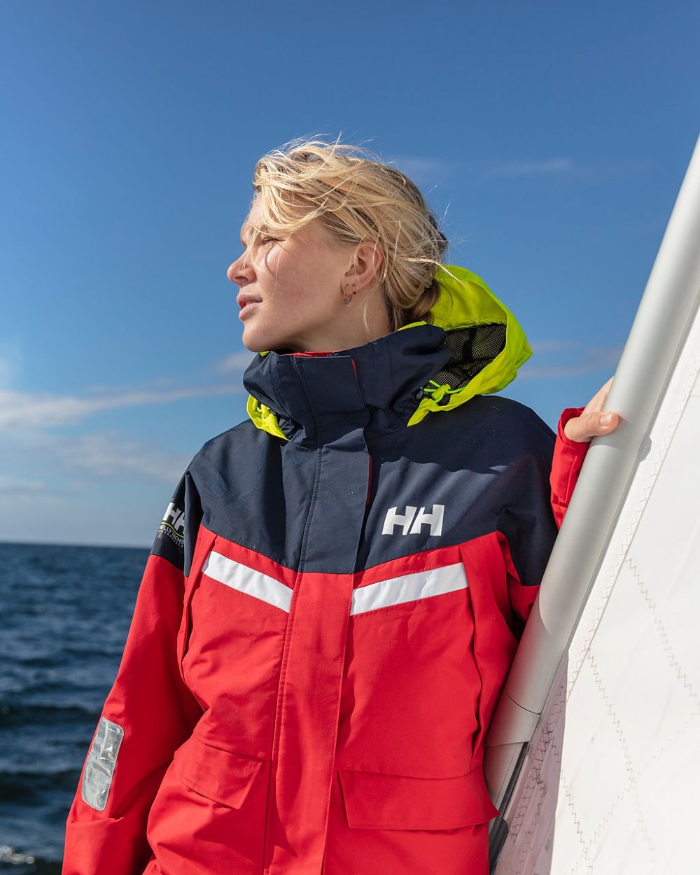Red coloured Helly Hansen Womens Pier 4.0 Jacket on blurry background 