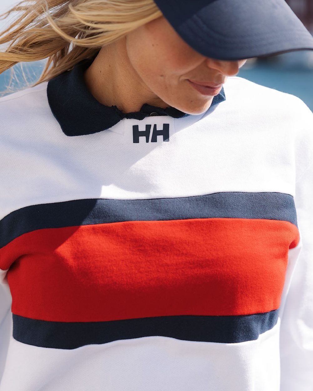 White coloured Helly Hansen Womens Salt Crew Sweatshirt on blurry background 