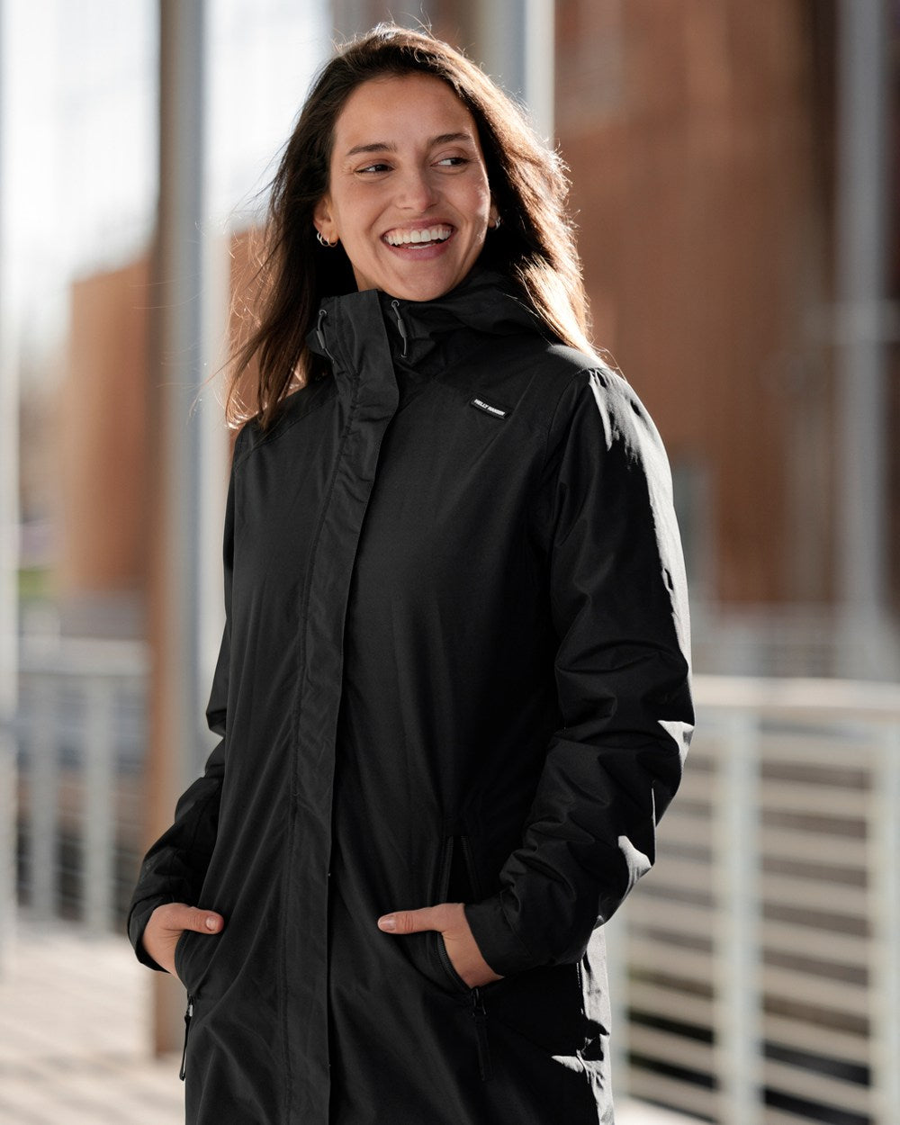 Black Coloured Helly Hansen Womens Valkyrie Fleece Lined Rain Jacket on blurry background 