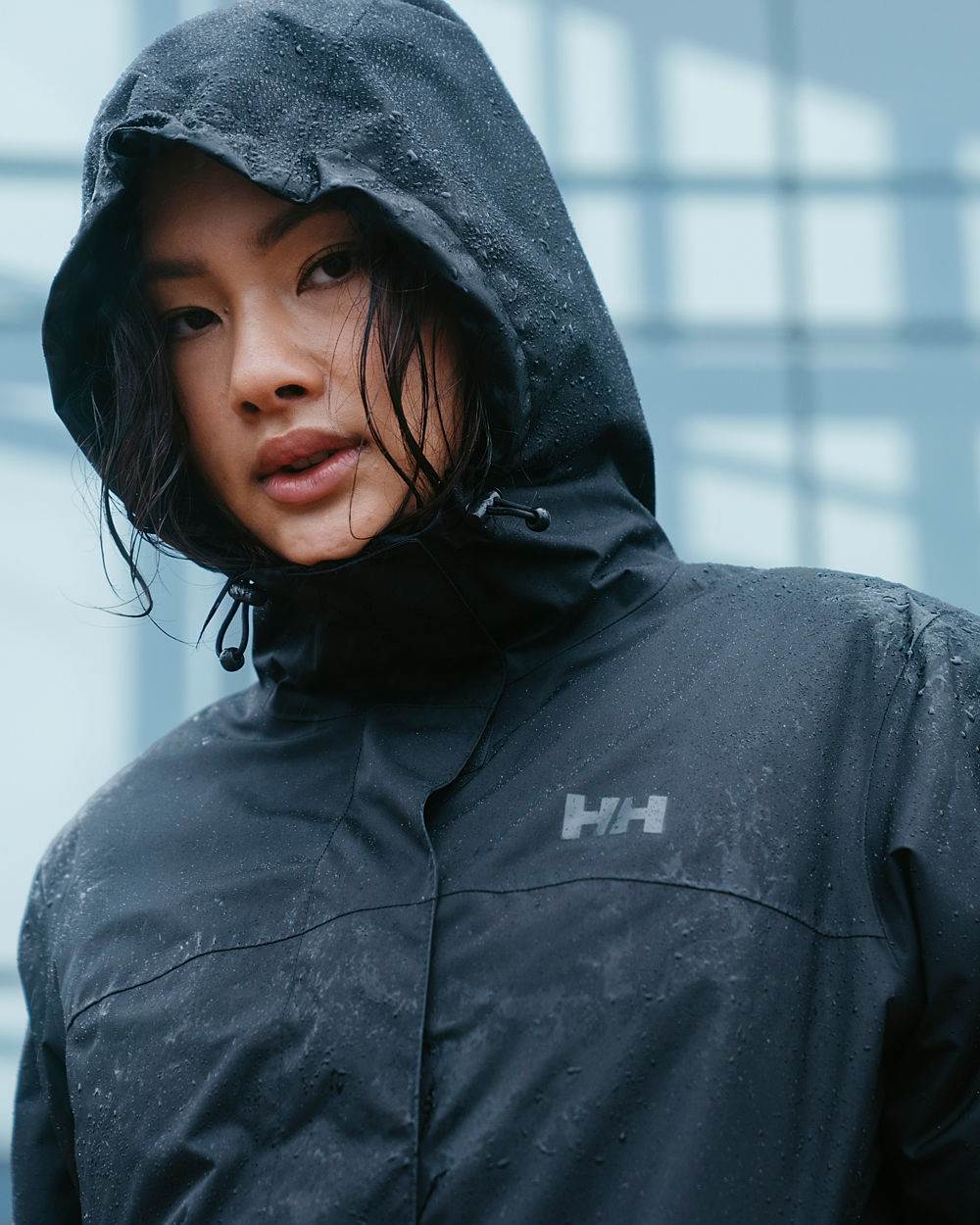 Black coloured Helly Hansen Womens Vancouver Rain Jacket on glass background 