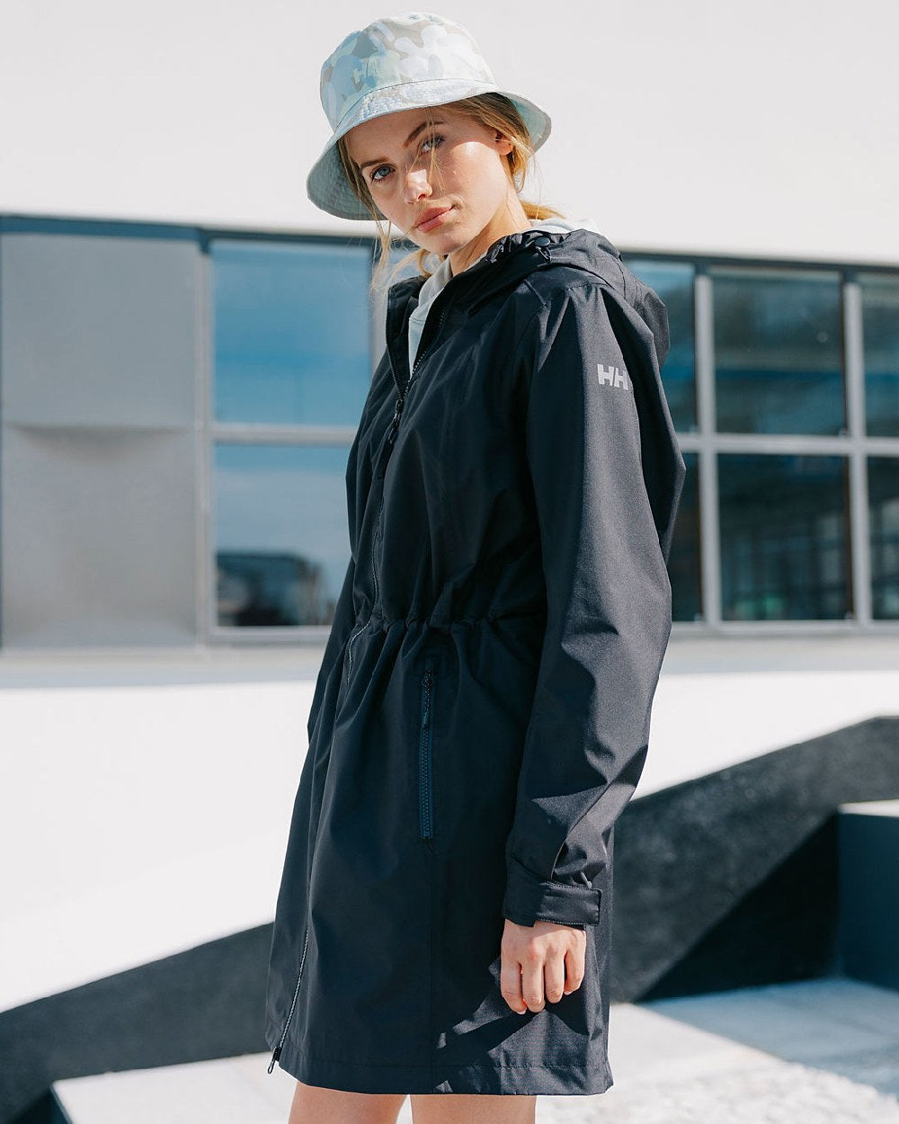 Black coloured Helly Hansen Womens Westport Raincoat on street background 