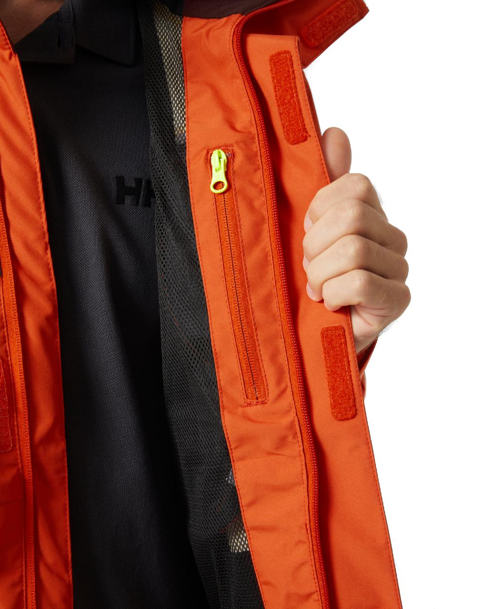 Patrol Orange coloured Helly Hansen Mens Newport Inshore Sailing Jacket on white background 