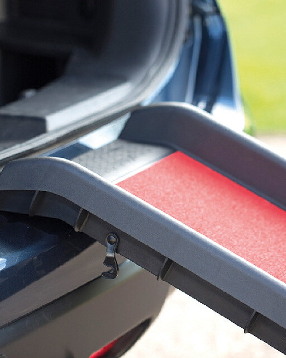 Black Red coloured Henry Wag Lightweight Folding Pet Ramp on car background 