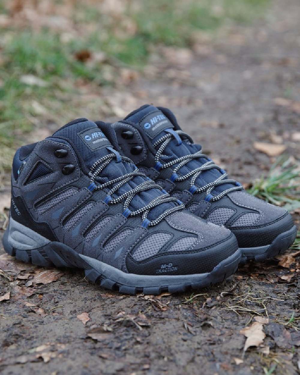 Charcoal coloured Hi-Tec Mens Corzo Mid Boots on trail background 