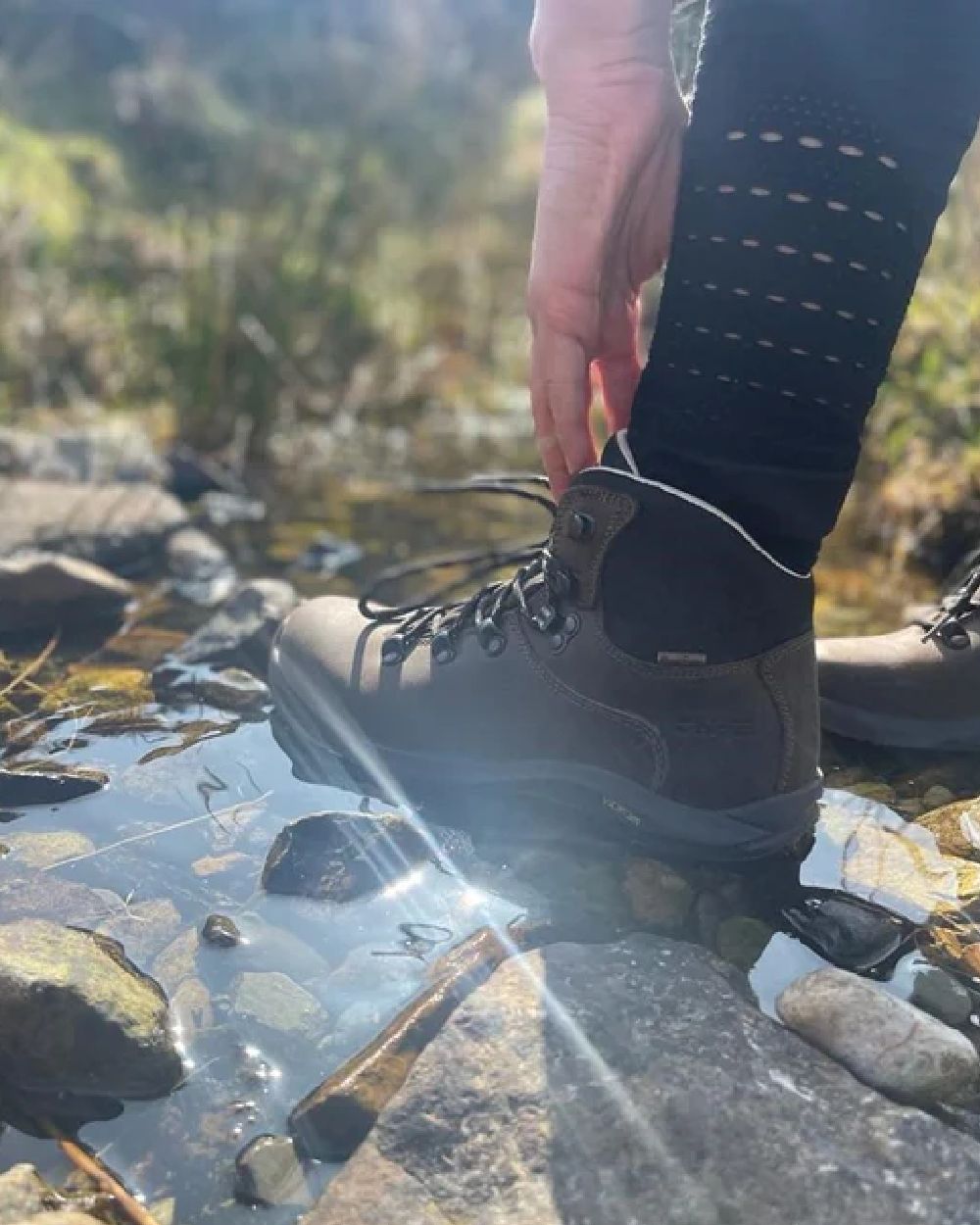 Brown Coloured Hi-Tec Womens Ravine Pro Boots on pond background 