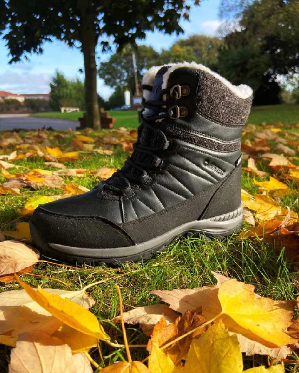 Black Coloured Hi-Tec Womens Riva Mid Boots on ground background 