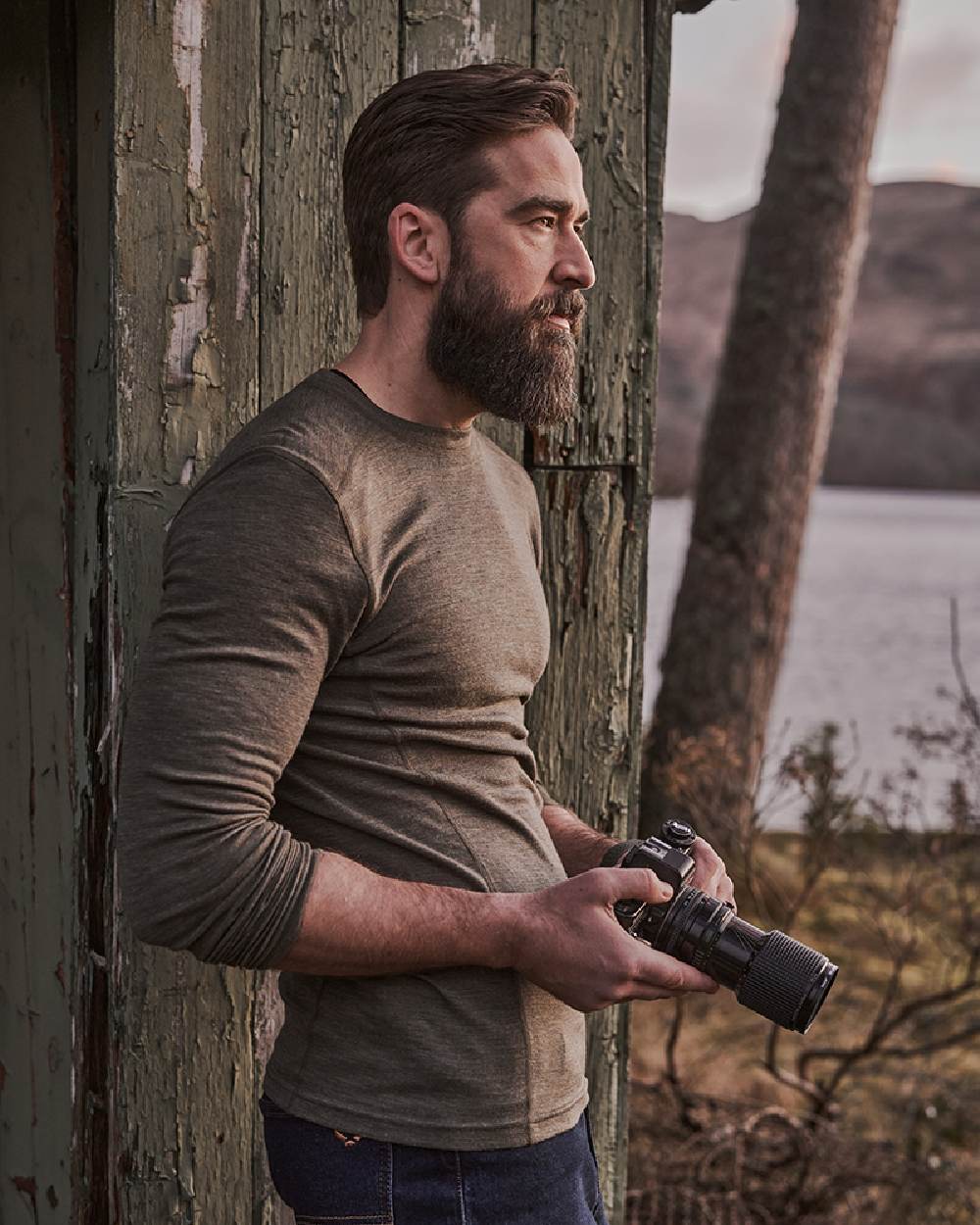 Green Coloured Hoggs of Fife 100% Merino Wool Long Sleeve Crew Neck Base Layer on lake background 