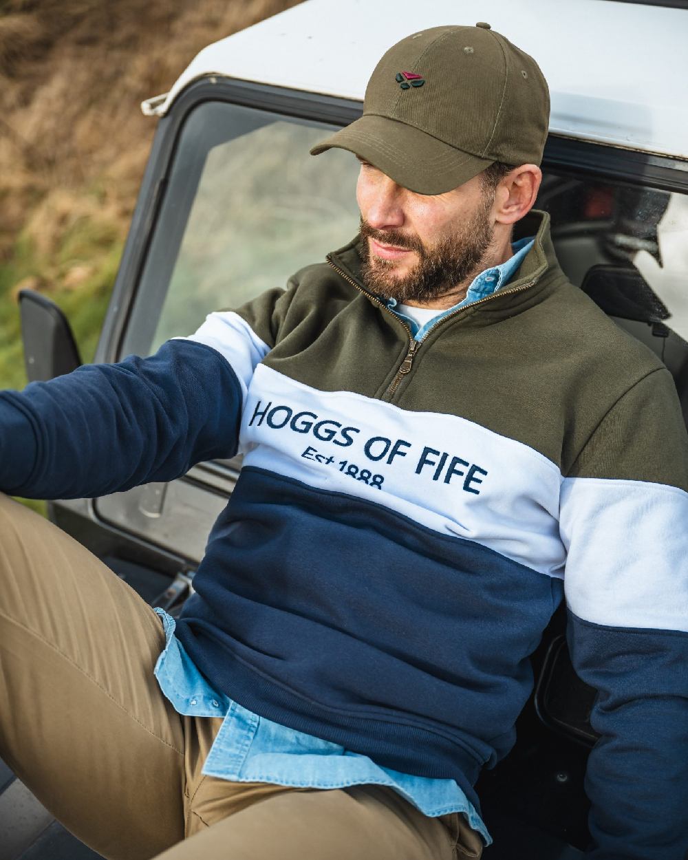 Olive Coloured Hoggs of Fife 1888 Baseball Cap on  car background 