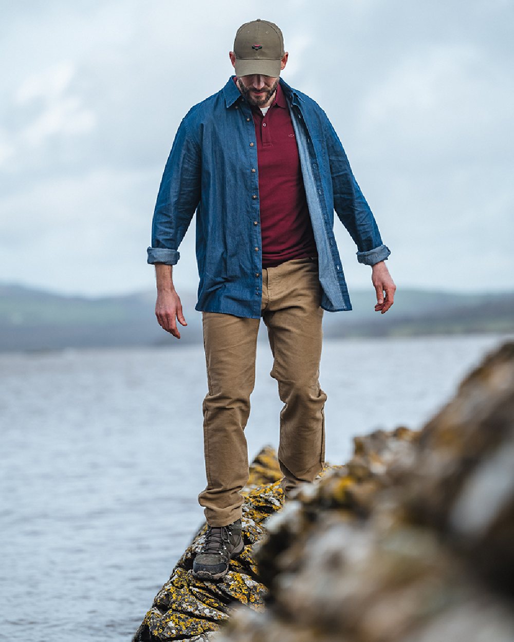 Dark Wash Coloured Hoggs of Fife Archerfield Denim Shirt on coastal background 