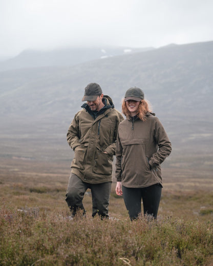 Dark Olive coloured Hoggs of Fife Mens Ardross Pro Waterproof Field Trousers on moorland background 