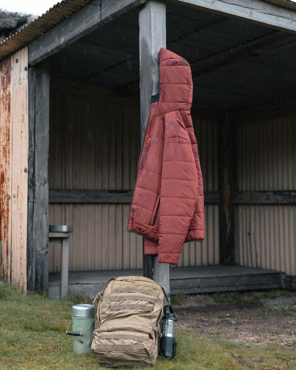Olive coloured Hoggs of Fife Mens Aviemore Reversible Insulated Jacket on farm background 