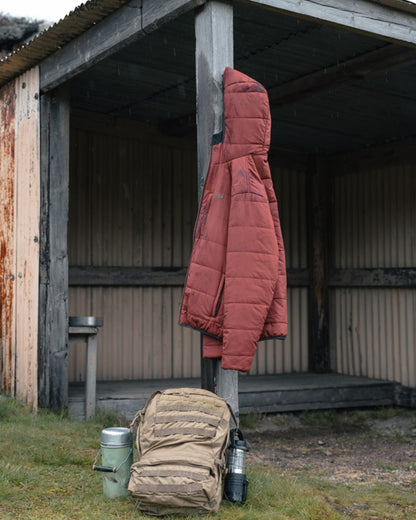 Olive coloured Hoggs of Fife Mens Aviemore Reversible Insulated Jacket on farm background 