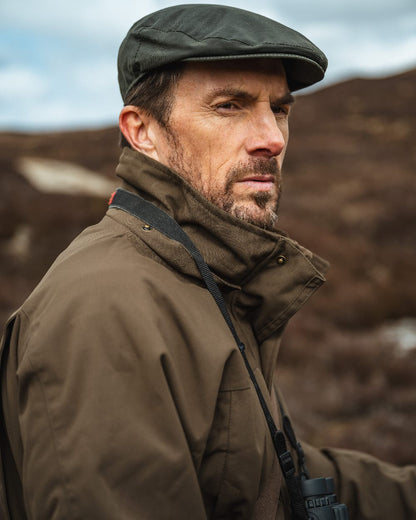 Green Coloured Hoggs of Fife Ballater Waterproof Field Jacket on blurry background 