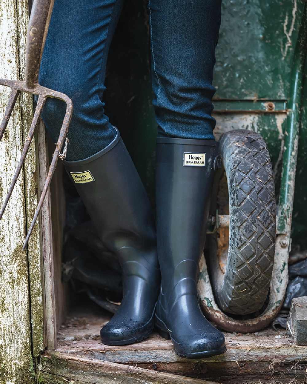 Navy Coloured Hoggs of Fife Braemar Wellingtons on storage room background 