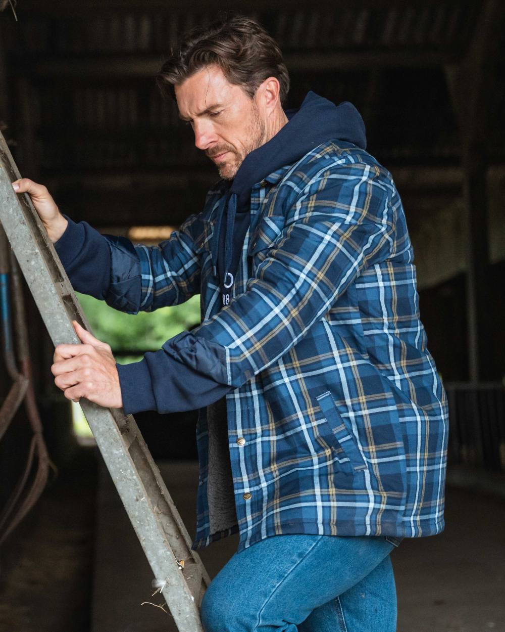 Navy Gold Coloured Hoggs of Fife Brunton Fleece Shacket on indoor background 