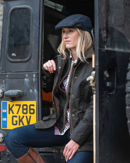 Antique Olive Coloured Hoggs of Fife Caledonia Ladies Antique Wax Jacket on outdoor background 