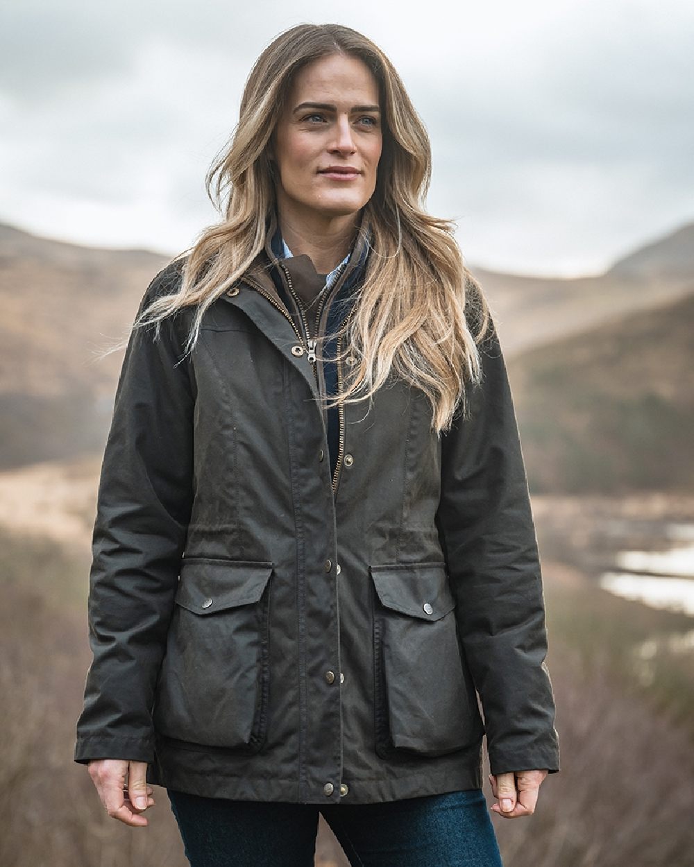 Antique Olive Coloured Hoggs of Fife Caledonia Ladies Antique Wax Jacket on blurry background 