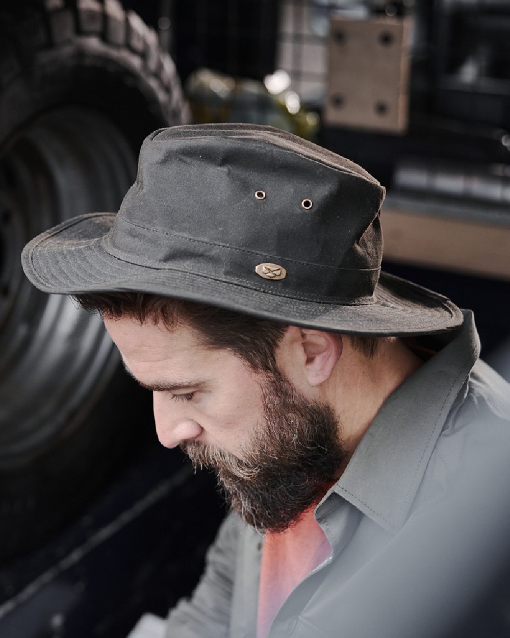 Antique Olive Coloured Hoggs of Fife Caledonia Waxed Hat on blurry background 