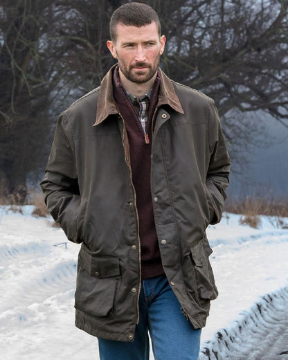 Olive Coloured Hoggs of Fife Caledonia Waxed Jacket on snow background 