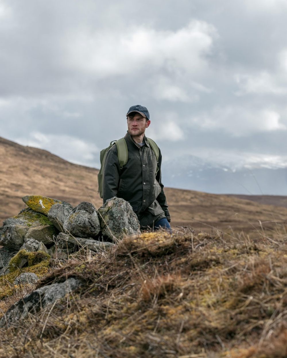 Olive Coloured Hoggs of Fife Caledonia Waxed Jacket on mountain background 