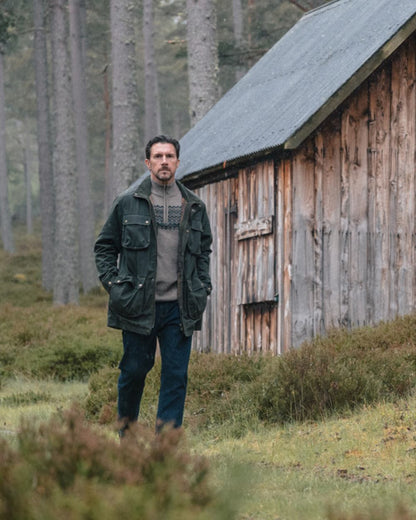 Oatmeal coloured Hoggs of Fife Mens Colonsay Fair Isle Quarter Zip Pullover on forest background 