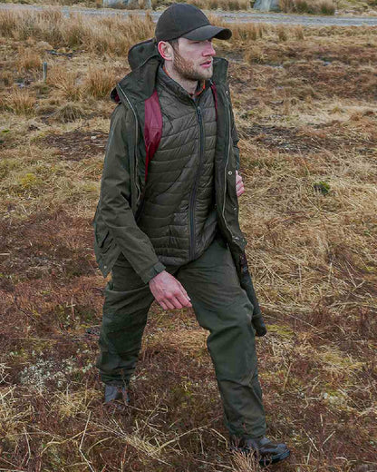 Fern Green Coloured Hoggs of Fife Culloden Waterproof Field Jacket on land background 