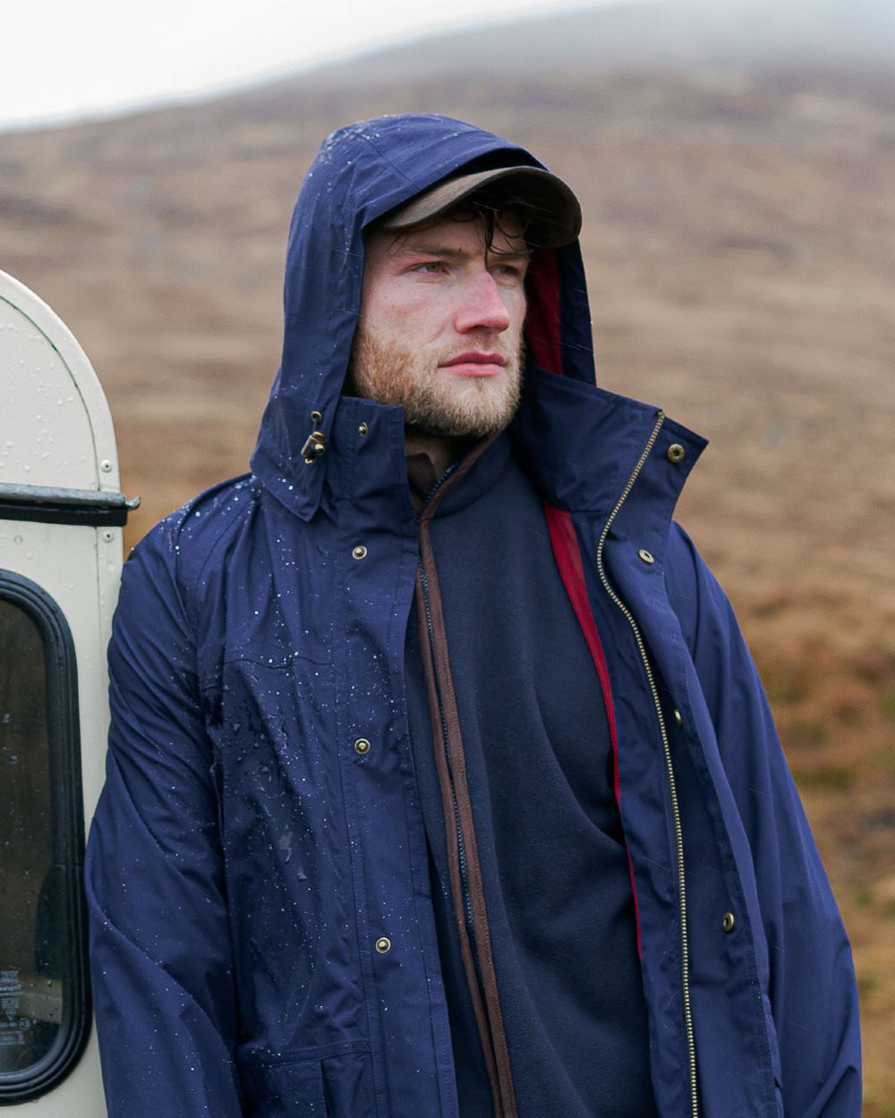 Navy Coloured Hoggs of Fife Culloden Waterproof Field Jacket on  mountain background 