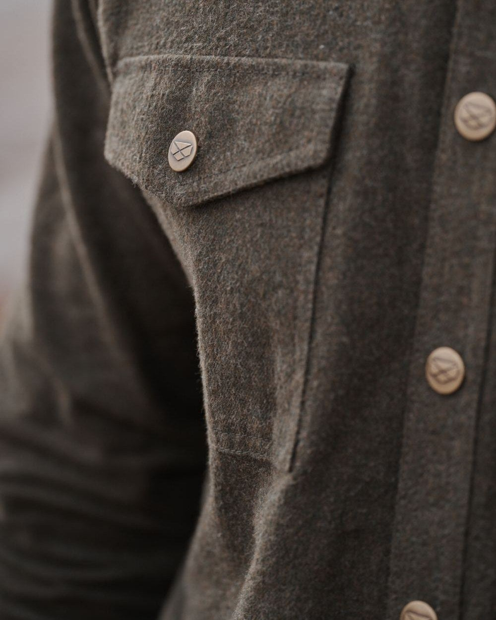 Loden Marl Coloured Hoggs of Fife Dunvegan Flannel Shirt on blurry background 