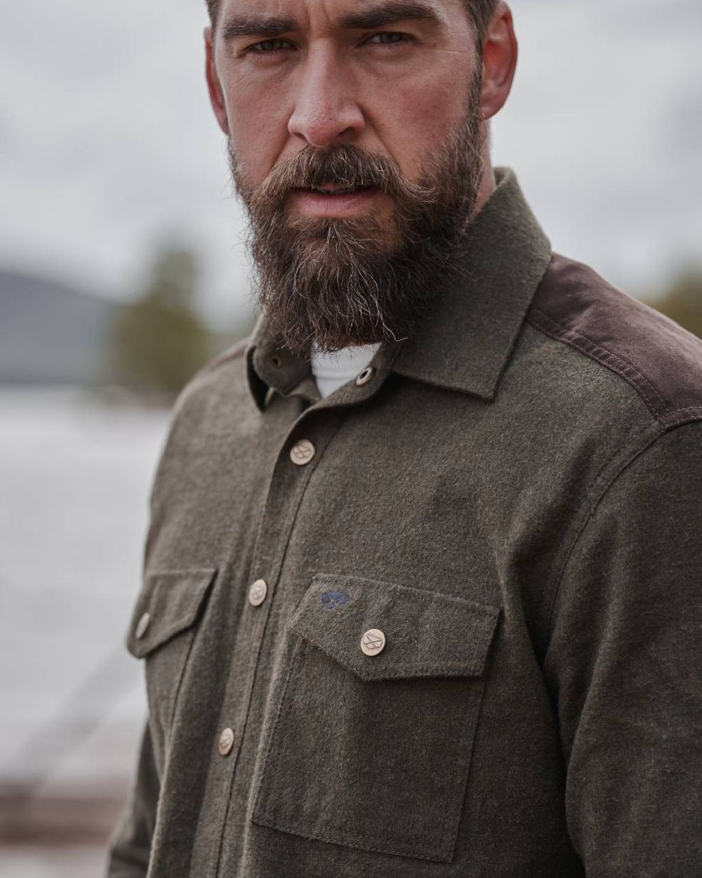 Loden Marl Coloured Hoggs of Fife Dunvegan Flannel Shirt on blurry background 