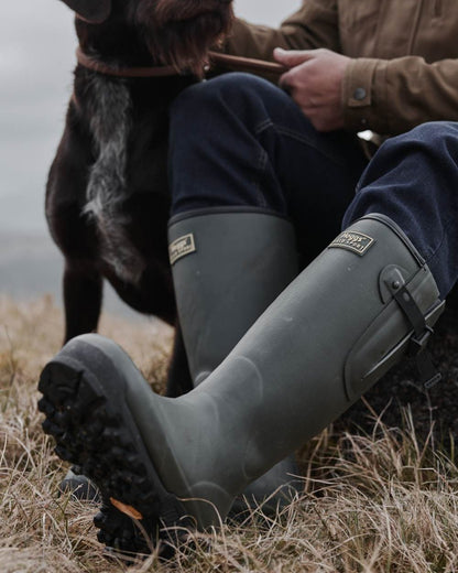 Field Green Coloured Hoggs of Fife Field Sport 365 Wellingtons on land background 