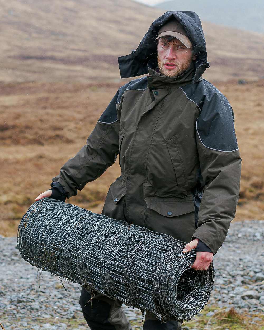 Green Coloured Hoggs of Fife Field Tech Waterproof Jacket on land background 